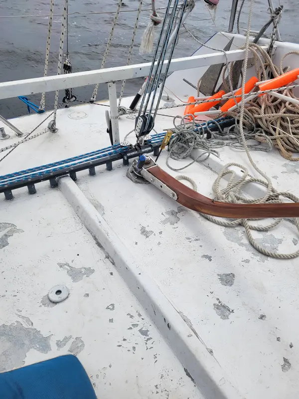Coiled lines and deck hardware on a white sailboat deck